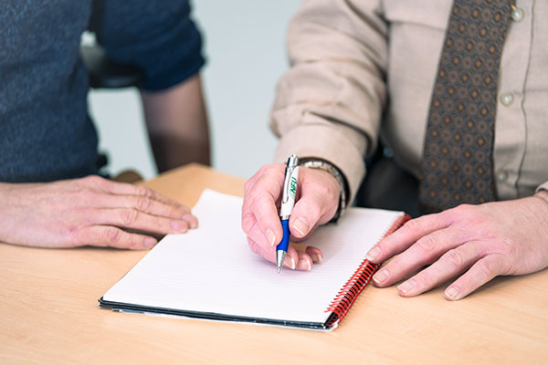 Two People Working Notebook Pen