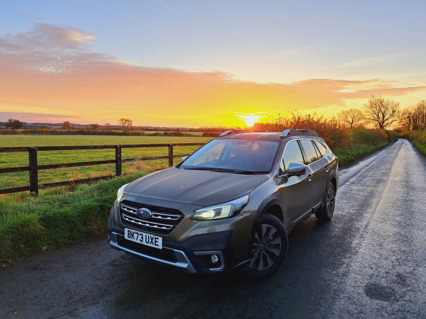 A Subaru drives along an English country road