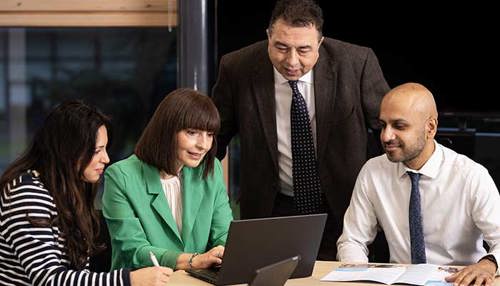 Office Workers At Laptop Hero Img