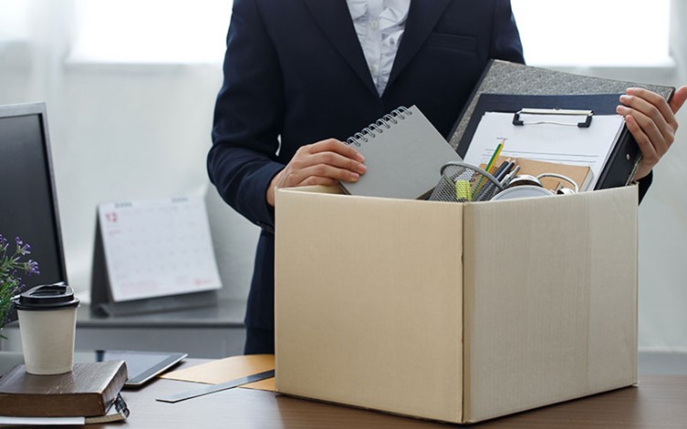 Office worker with box of belongings